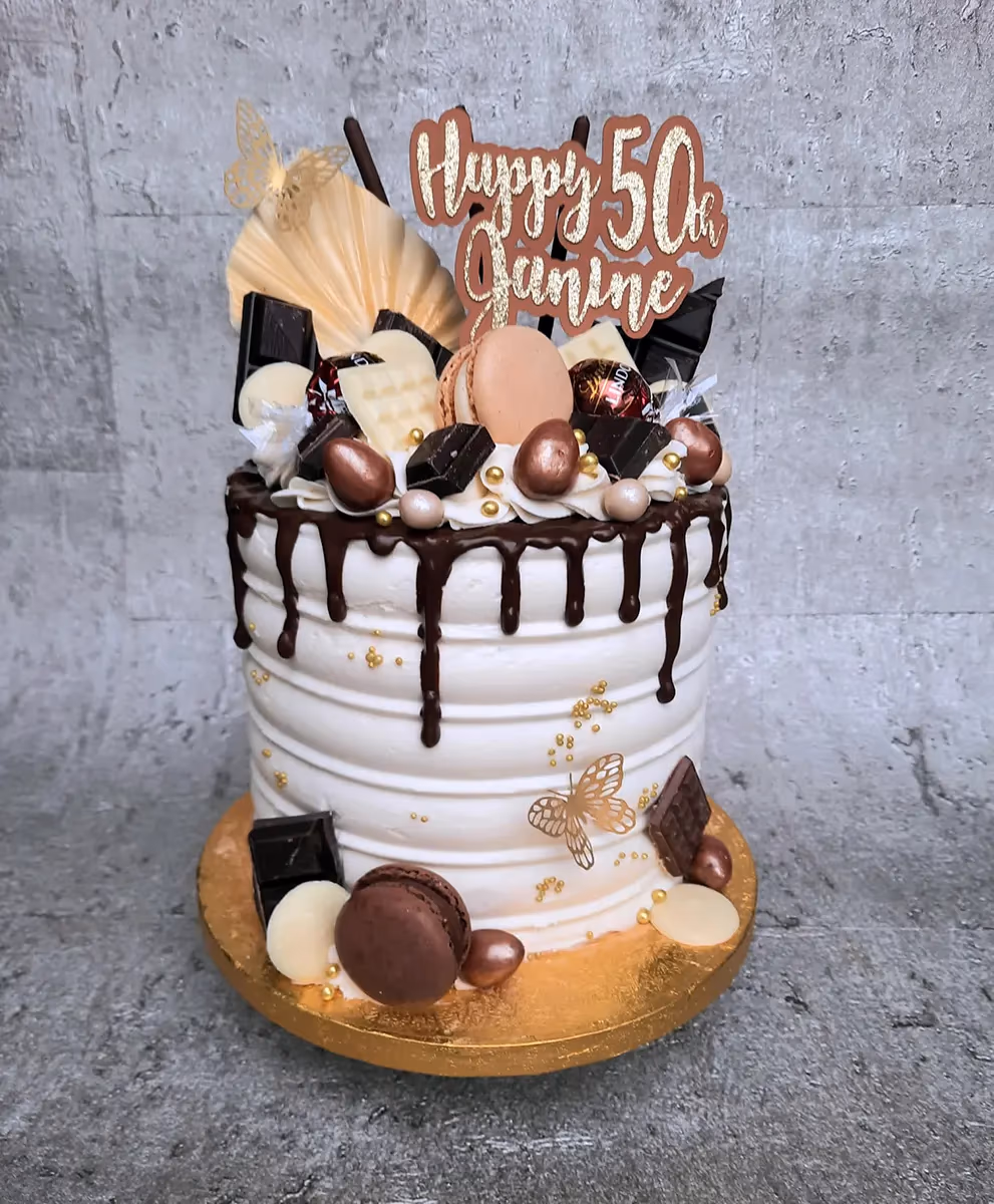 White chocolate drip 50th birthday cake with gold decorations