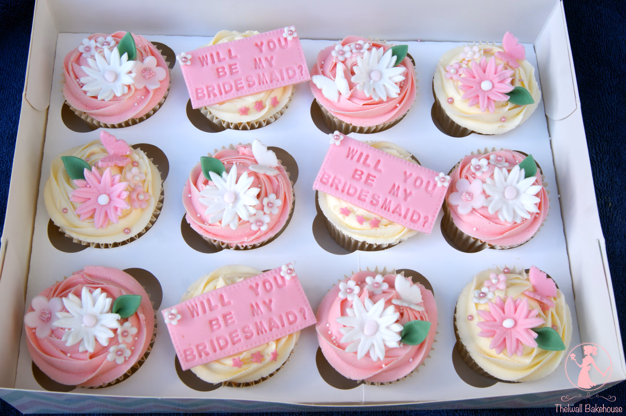 Pink and white bridesmaid proposal cupcakes with flowers and butterfly decorations