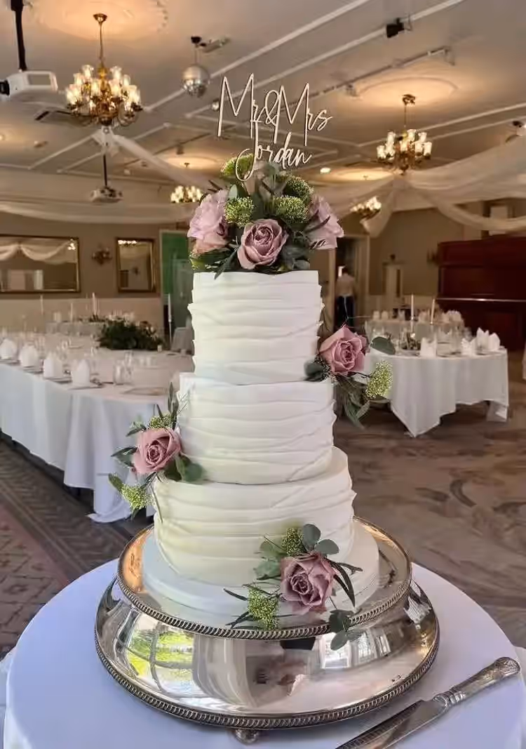 Geraldine holding a bespoke celebration cake