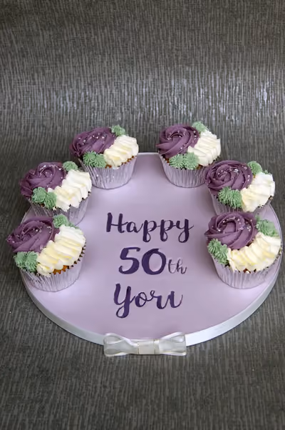Purple and cream rose cupcakes for a 50th birthday by Thelwall Bakehouse