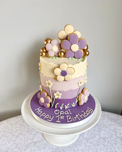 Purple ombre first birthday cake with flower biscuits for Opal by Thelwall Bakehouse
